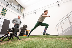 An athlete runs on artificial turf in the lab